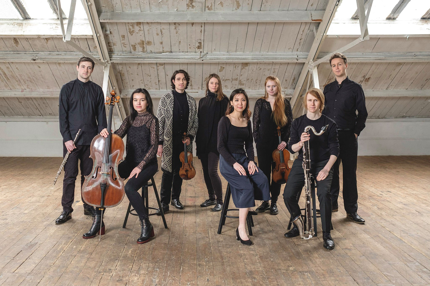 Eight chamber musicians looking at the camera