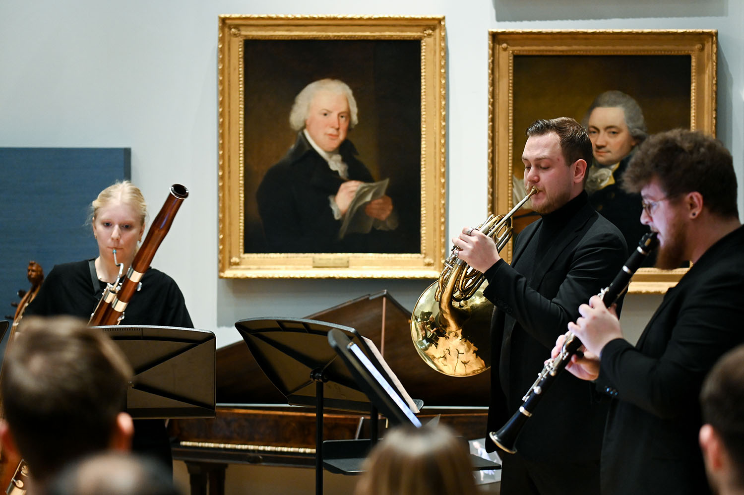 Three musicians perform in the RCM Museum