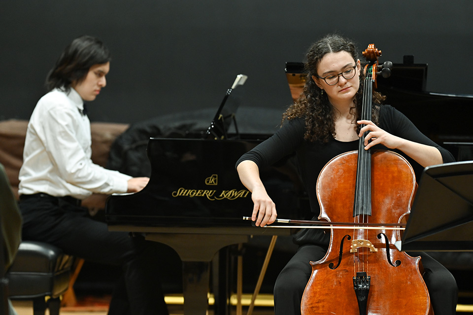 A pianist and cellist perform together onstage