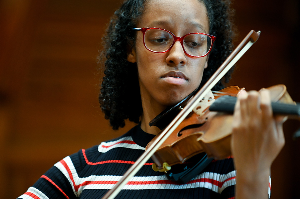 A close-up image of an RCM student violinist performing