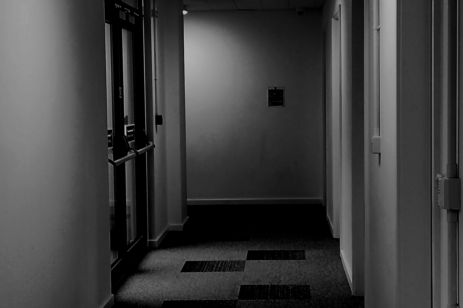 A black and white image of an empty corridor