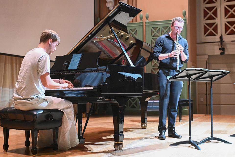 A pianist and clarinetist perform on stage