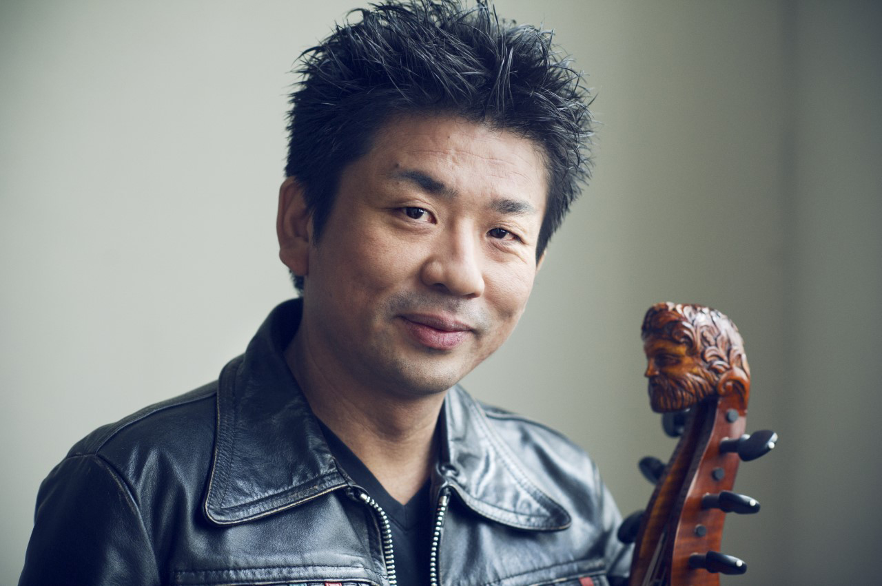 Atsushi Sakai smiling at the camera, holding his viol