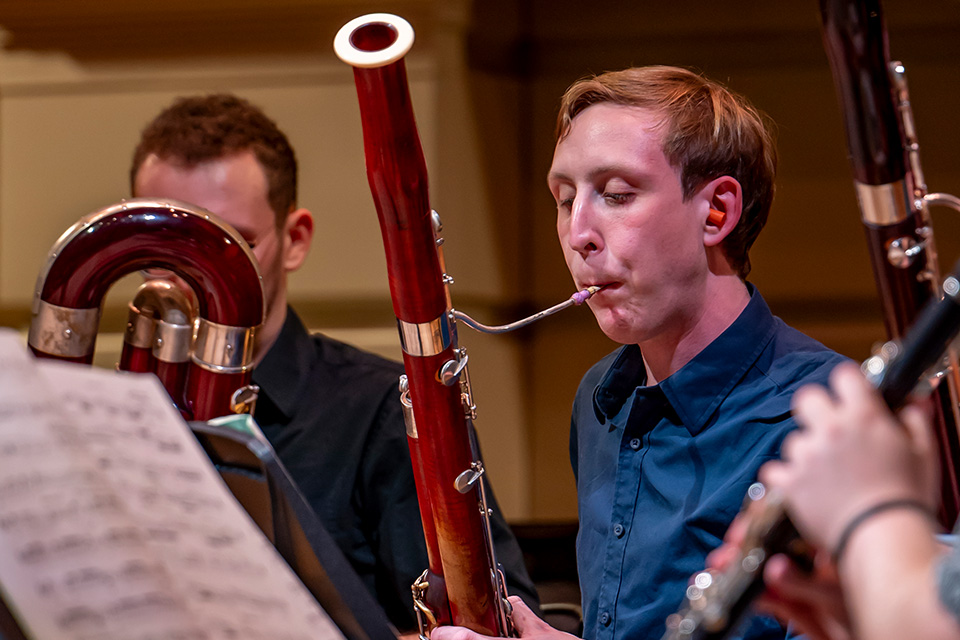 A bassonists plays his instrument on stage