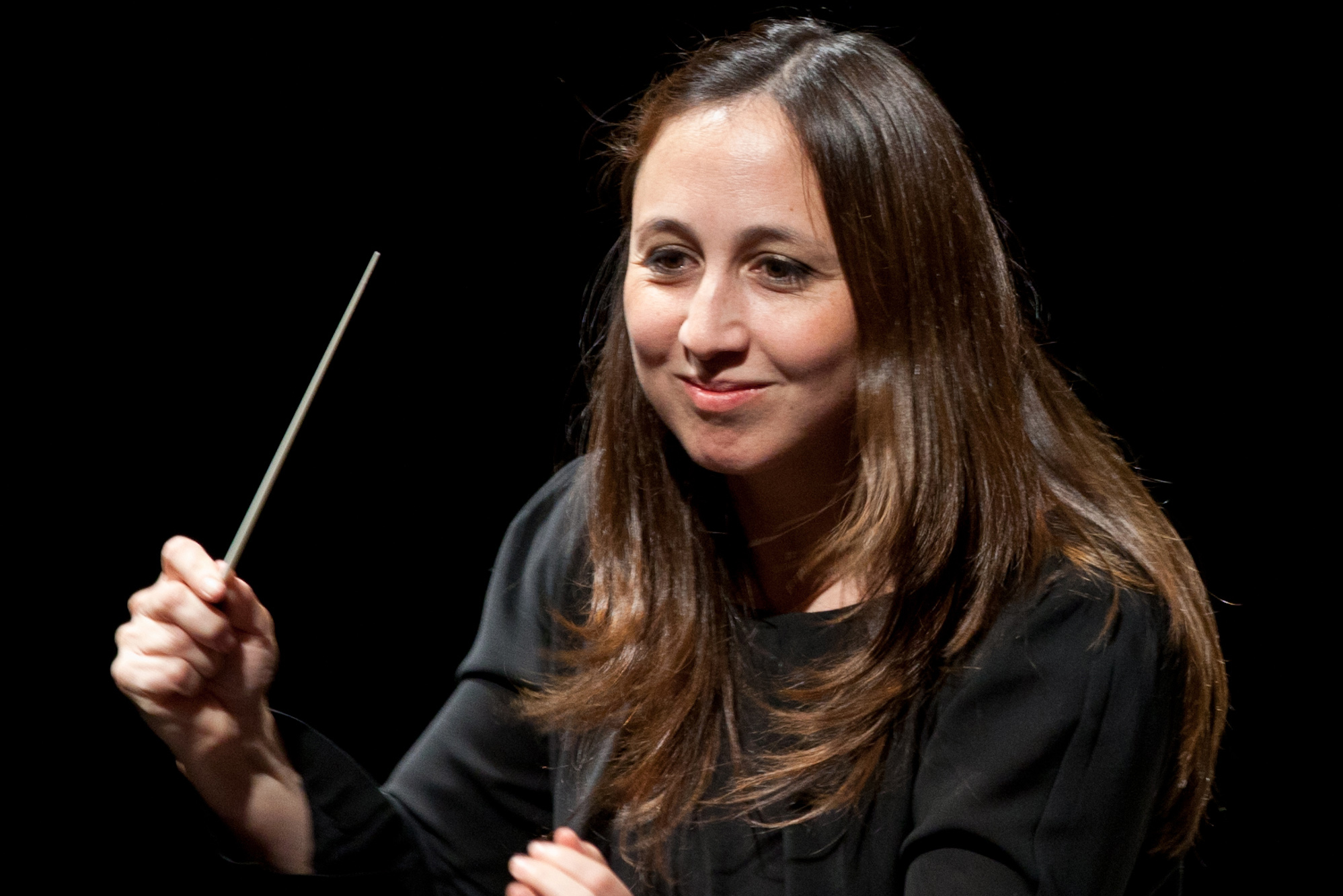 Joana Carneiro conducting against a dark background
