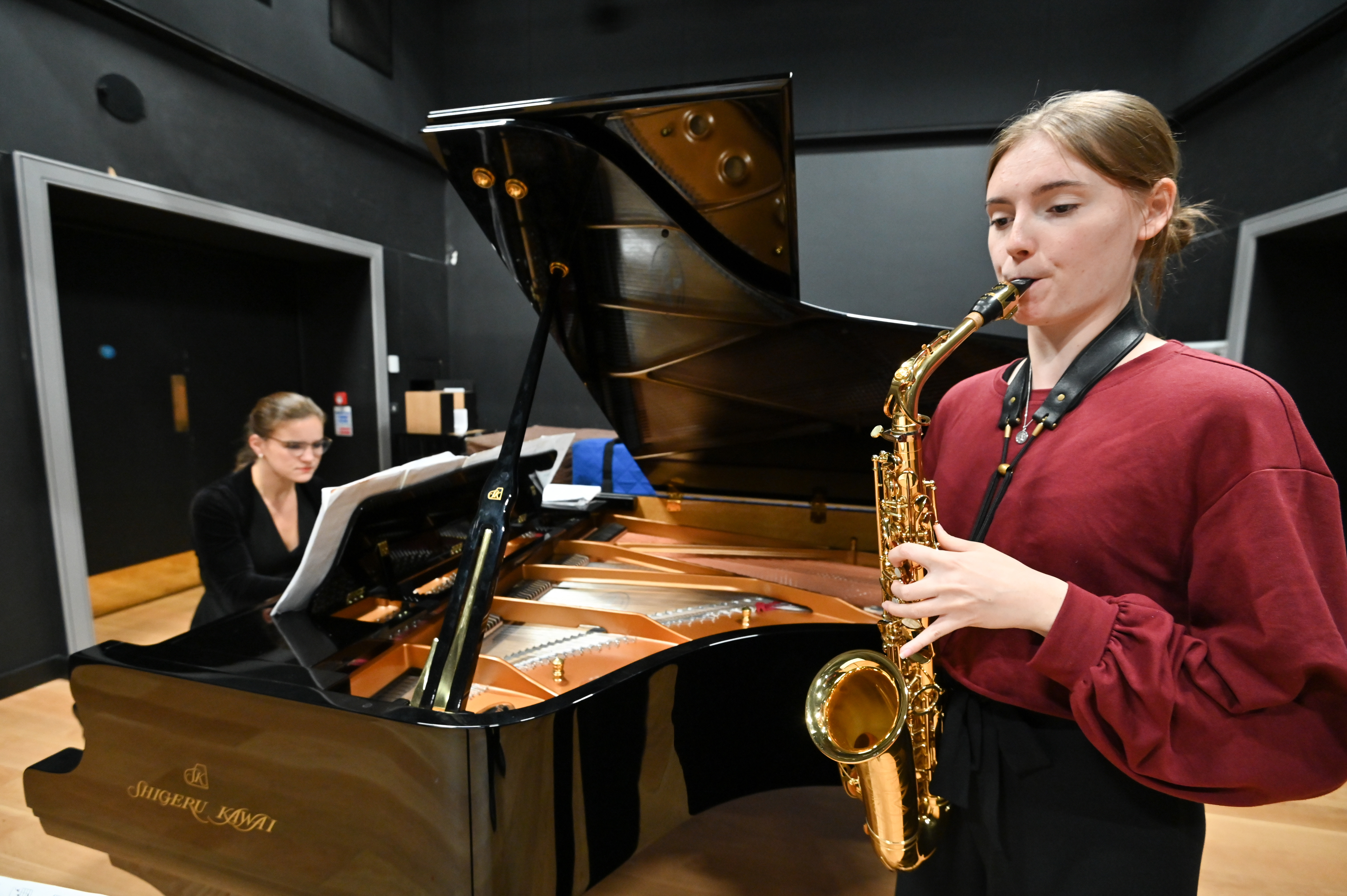 A saxophonist and pianist perform in the Performance Studio