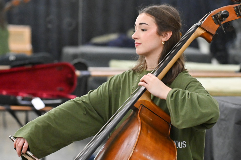 A young woman plays the double bass