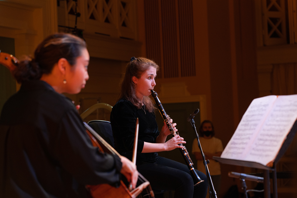 A cellist and clarinettist perform on stage in the RCM's Performance Hall