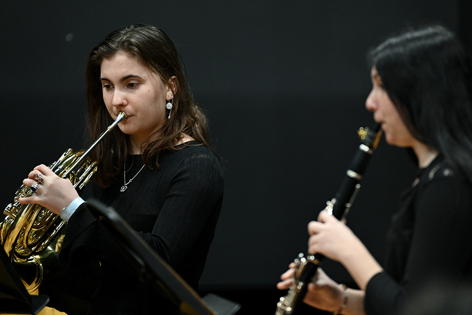 A french horn and clarinet player in the RCM Performance Studio