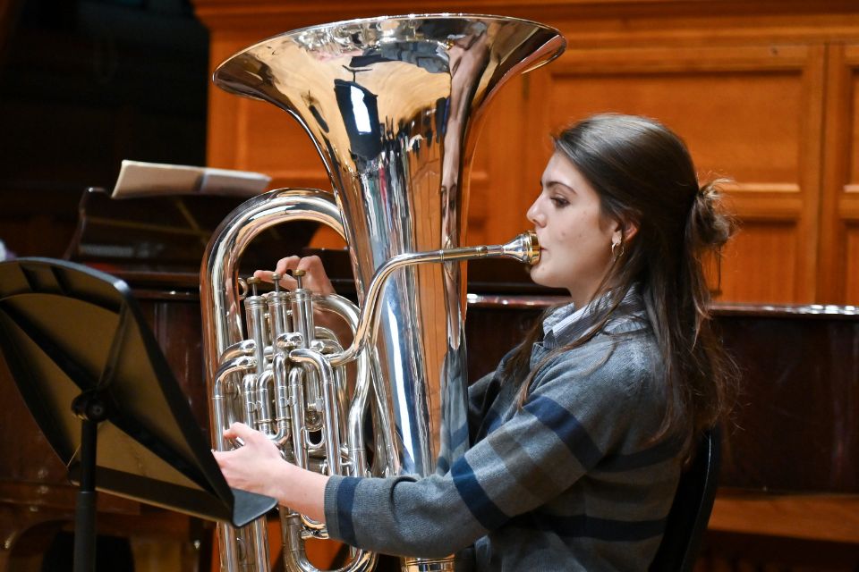A woung woman plays the tuba