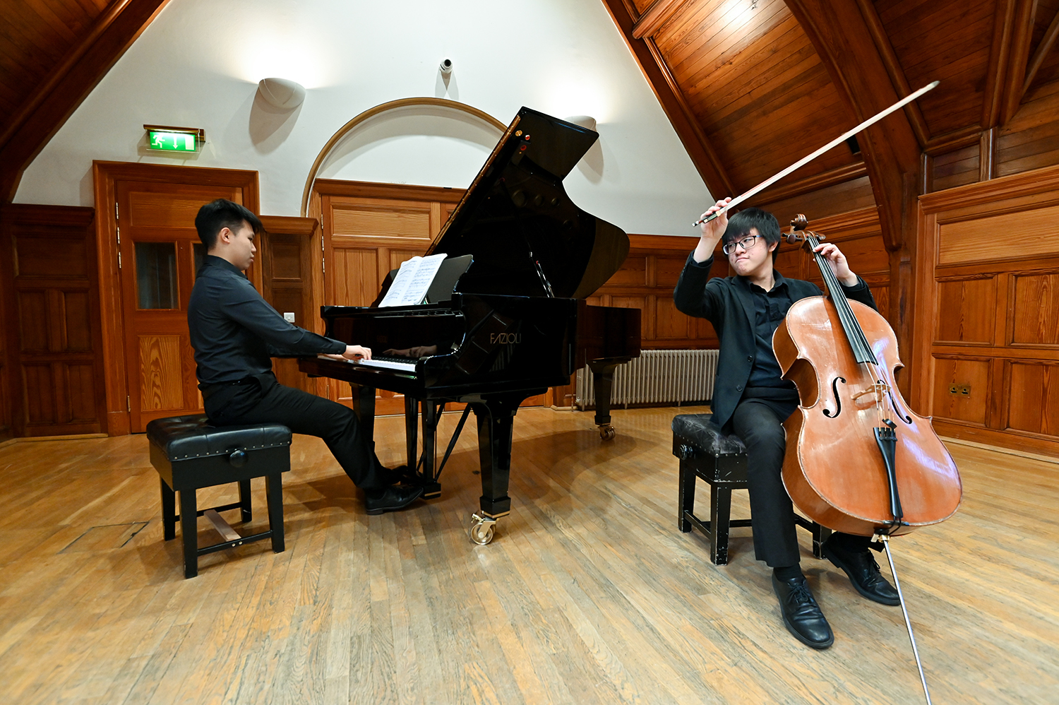 A cellist and pianist performing together in the Parry Rooms