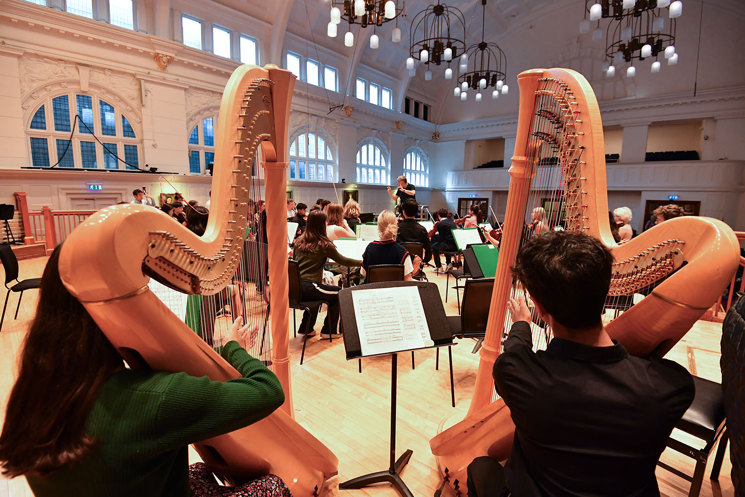 Harpists on stage in the Amaryllis Fleming Concert Hall
