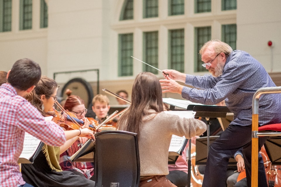 Martyn Brabbins conducts String players of the RCM Symphony Orchestra