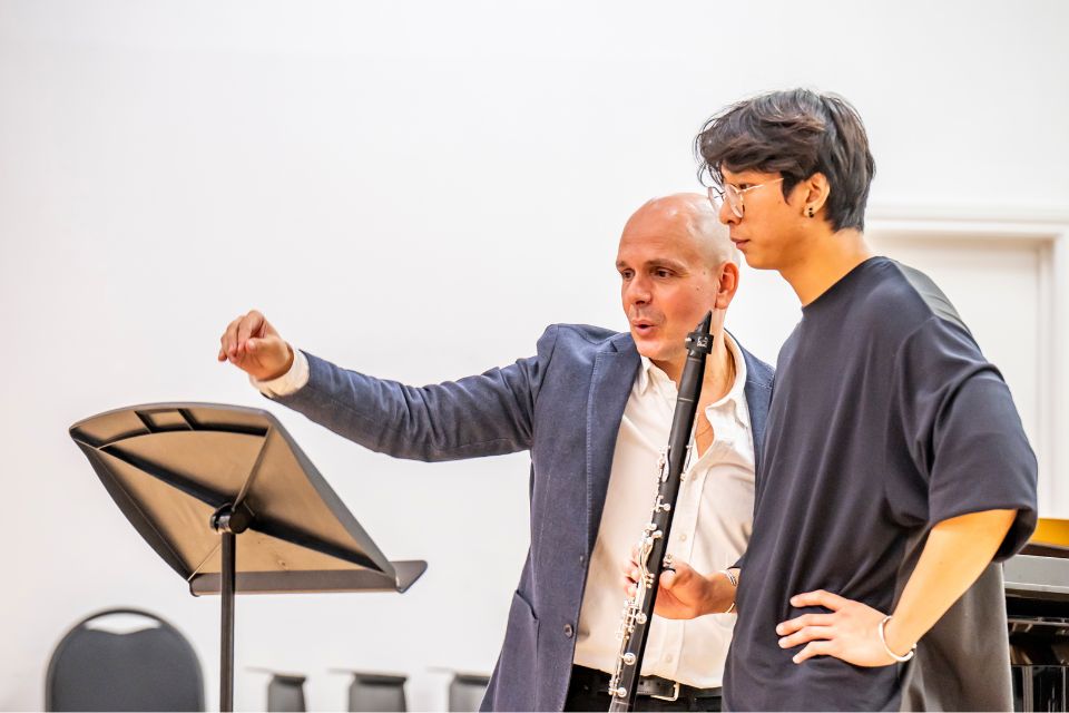 Maximiliano Martin teaches a young man holding a clarinet