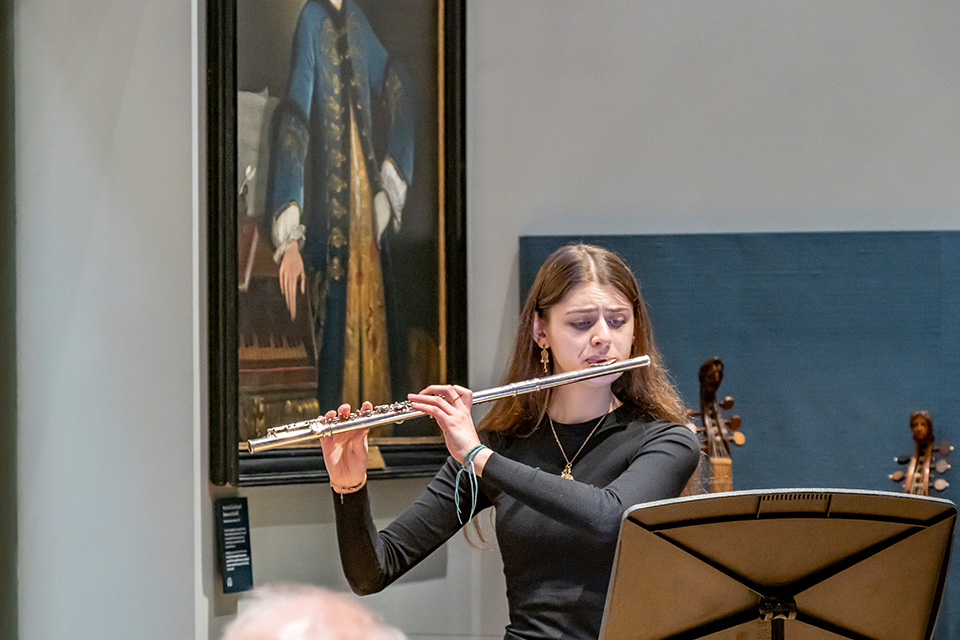 A flautist performs in the RCM Museum