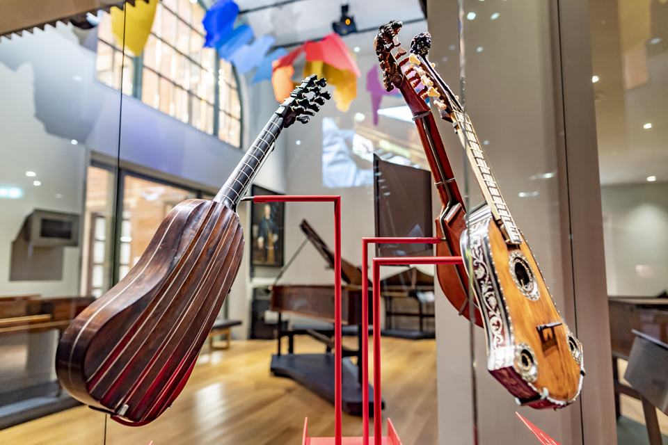 Historical guitars in a glass display case in the Royal College of Music Museum