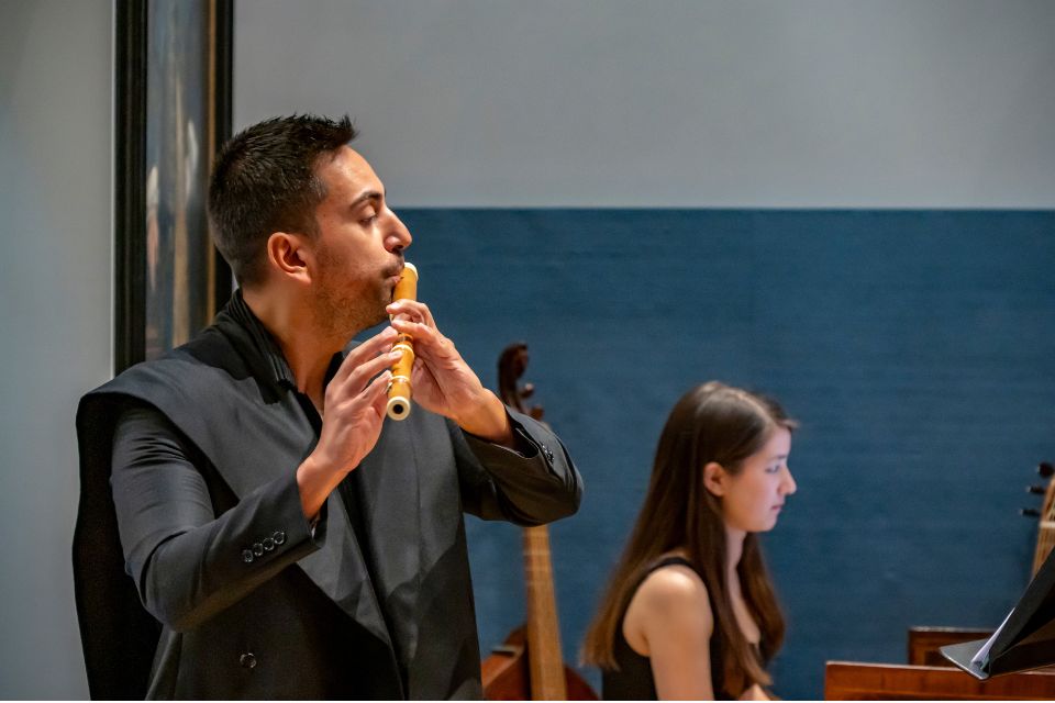 A man plays the recorder in the RCM Museum