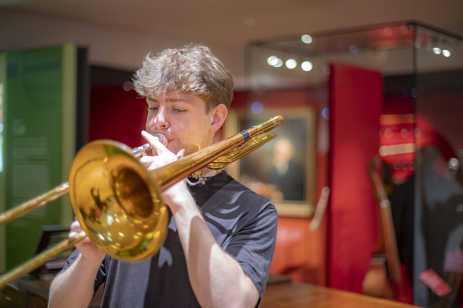 A man playing a trombone in the RCM Museum