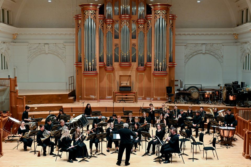 A large chamber ensemble perform on stage in the Amaryllis Fleming Concert Hall