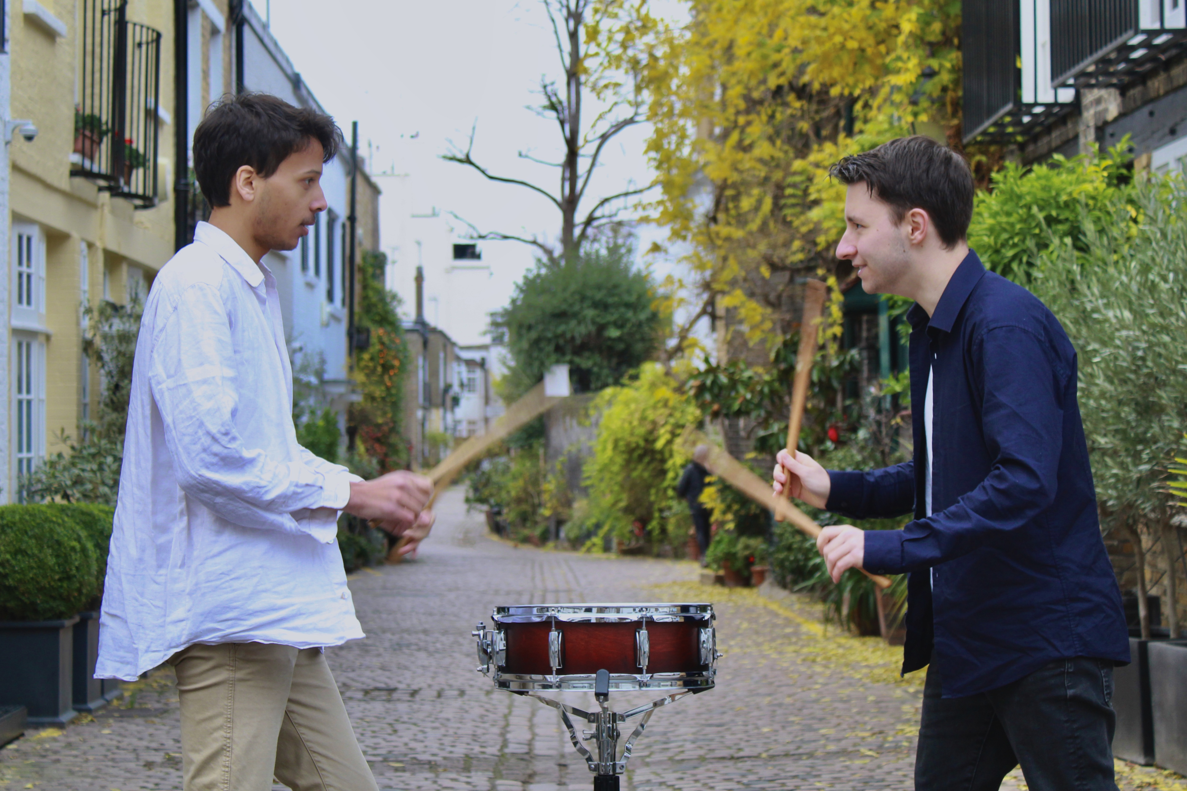 Sirocco Duo playing a drum together on a London street