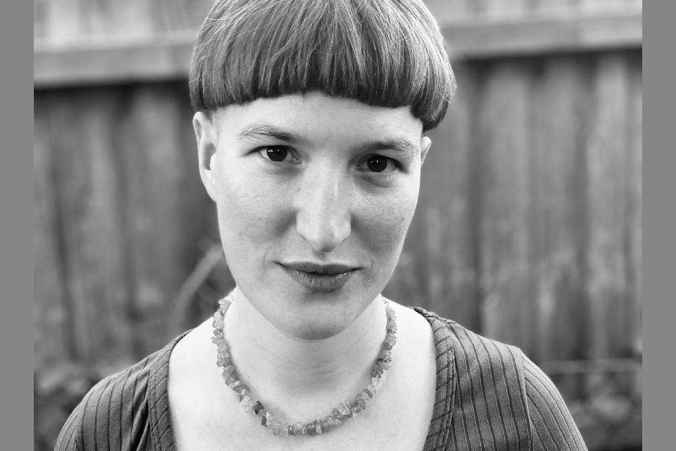 A black and white photo of Sophie Crawford, a young woman standing outside