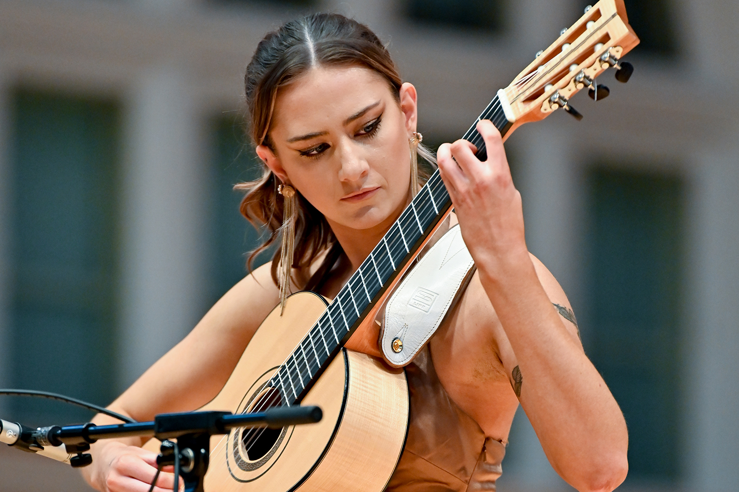 A woman playing classical guitar