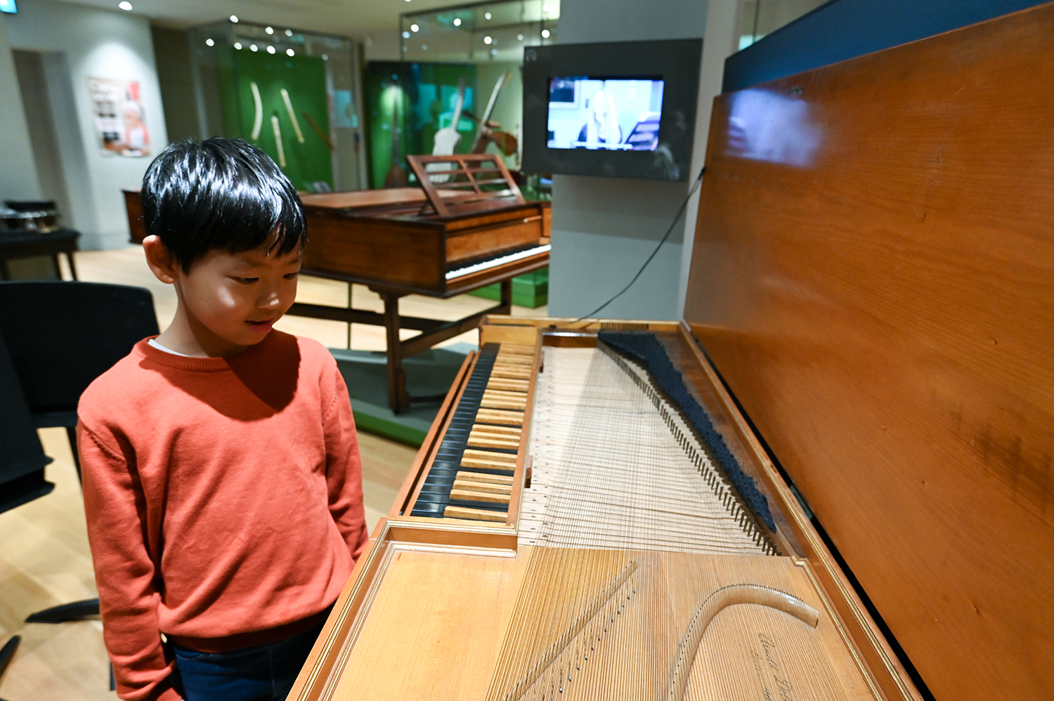 A young boy looks at an old instrument in the RCM Museum