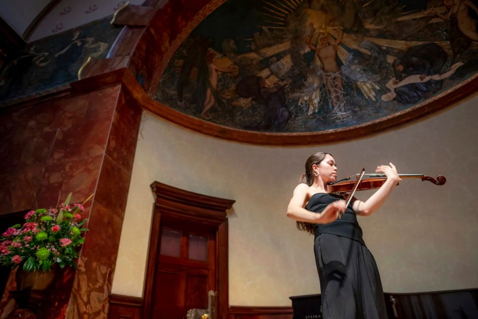 A violinist performs on stage in the Wigmore Hall