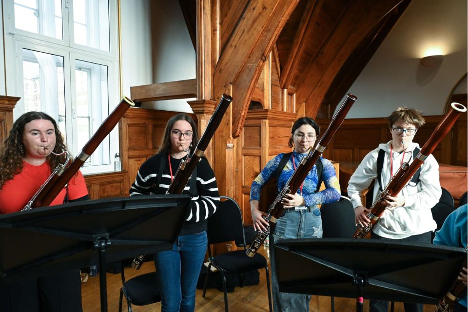 Four young bassonists play their instruments together