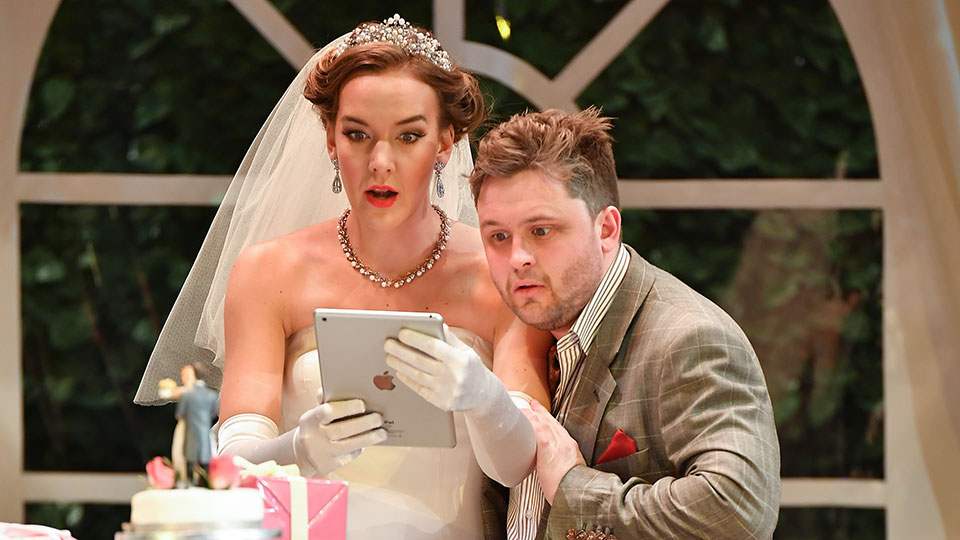 RCM singers viewing an ipad in the Royal College of Music International Opera School's production of La finta giardiniera RCM singers viewing an ipad in the Royal College of Music International Opera School's production of La finta giardiniera